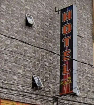 a sign on the side of a brick building at Hotel Minorista plaza in Medellín