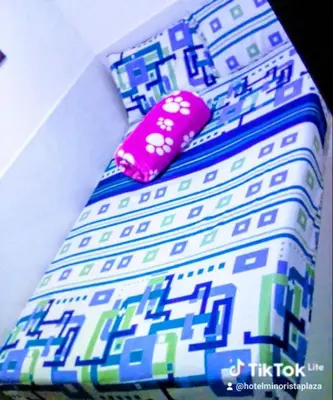 a close up of a colorful tie with a pink accessory at Hotel Minorista plaza in Medellín