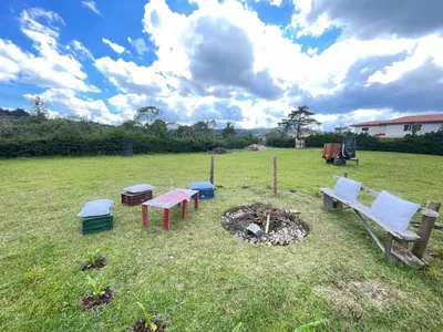 a group of benches and a fire pit in a field at Casa Campestre Familiar in Medellín