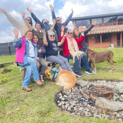 a group of people posing for a picture next to a fire at Casa Campestre Familiar in Medellín