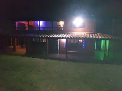 a building with a light on the top of it at night at Casa Campestre Familiar in Medellín