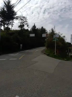 an empty road with a sign on the side at Casa Campestre Familiar in Medellín