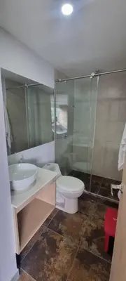 a bathroom with a toilet and a sink and a shower at Laureles City Retreat, Cold AC in Medellín