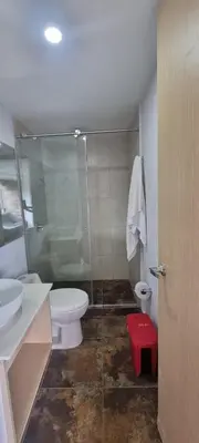 a bathroom with a toilet and a glass shower at Laureles City Retreat, Cold AC in Medellín