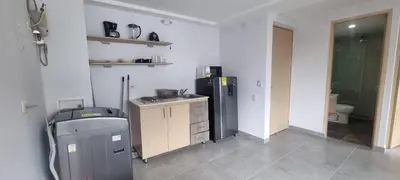 a kitchen with a sink and a refrigerator at Laureles City Retreat, Cold AC in Medellín