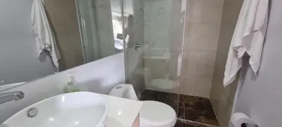 a bathroom with a white toilet and a shower at Laureles City Retreat, Cold AC in Medellín