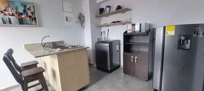 a kitchen with a counter and a refrigerator and a sink at La 70, Laureles Condo, Cold AC in Medellín