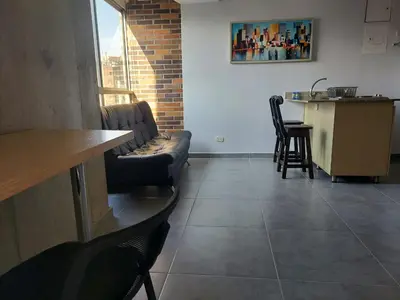 a living room with a couch and a table at La 70, Laureles Condo, Cold AC in Medellín