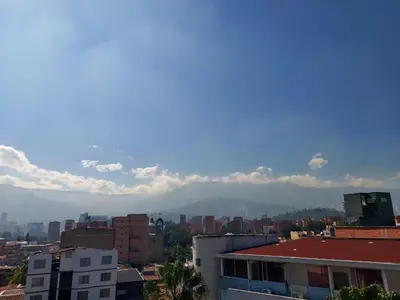 a view of a city with mountains in the background at La 70, Laureles Condo, Cold AC in Medellín