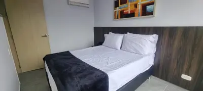 a bedroom with a bed with a wooden headboard at La 70, Laureles Condo, Cold AC in Medellín