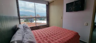 a bedroom with a bed and a large window at Best Laureles location and price in Medellín