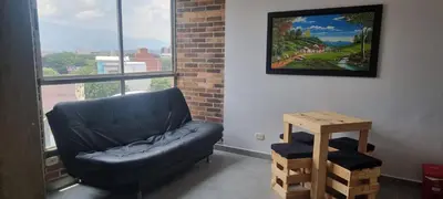 a blue couch sitting in a room with a window at Best Laureles location and price in Medellín