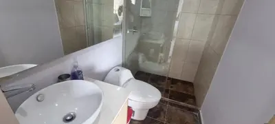 a white bathroom with a toilet and a sink at Best Laureles location and price in Medellín