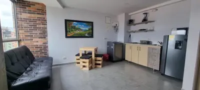 a living room with a couch and a kitchen at Best Laureles location and price in Medellín