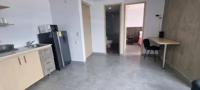 a kitchen with a refrigerator and a table in it at Best Laureles location and price in Medellín