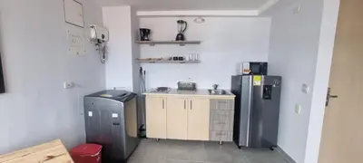 a small kitchen with a sink and a refrigerator at Best Laureles location and price in Medellín