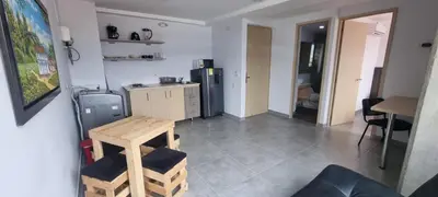a kitchen with a counter and a table in a room at Great Laureles views, Cold AC and best price in Medellín