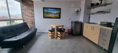 a living room with a couch and a kitchen at Great Laureles views, Cold AC and best price in Medellín