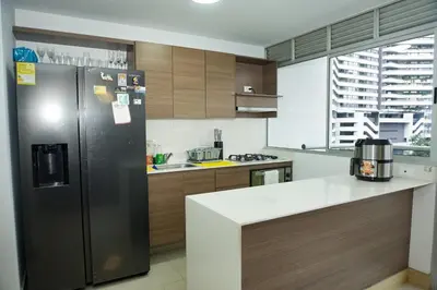 a kitchen with a stainless steel refrigerator and a counter at Luxurious apartment in Las Palmas in Medellín