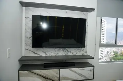 a flat screen tv on a wall in a living room at Luxurious apartment in Las Palmas in Medellín