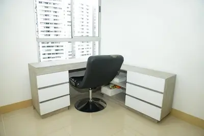 a desk with a black chair in front of a window at Luxurious apartment in Las Palmas in Medellín