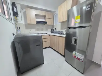 a kitchen with a stainless steel refrigerator and a sink at Elegant apartment Laureles Estadio in Medellín