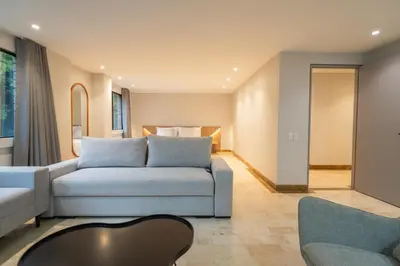 a living room with a couch and a table at Lux Lleras l Daily Cleaning l AC l Visitrs Allowed in Medellín