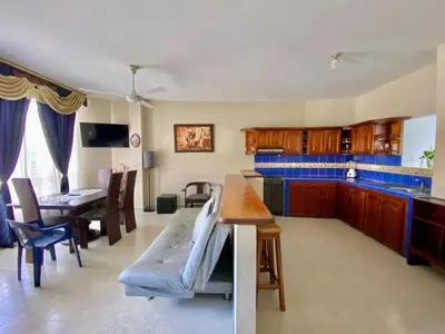 a kitchen and living room with a couch and a table at Casa de descanso en Doradal Hacienda Napoles in Doradal
