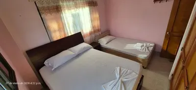 a small room with two beds and a window at Casa de descanso en Doradal Hacienda Napoles in Doradal