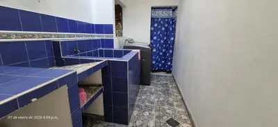 a blue tiled bathroom with a sink and a shower at Casa de descanso en Doradal Hacienda Napoles in Doradal