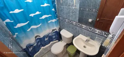 a bathroom with a sink and a toilet and a shower curtain at Casa de descanso en Doradal Hacienda Napoles in Doradal