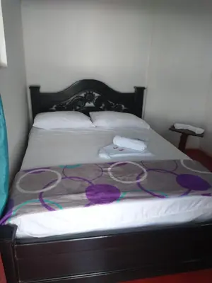 a bed with a bunch of purple cords on it at Casa de descansó la pradera