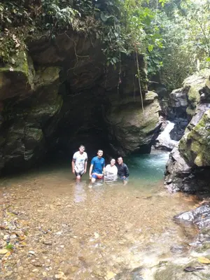 a group of people standing in the water in a cave at Casa de descansó la pradera