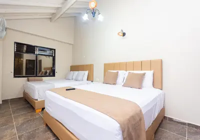 a bedroom with two beds and a window at Hotel Bossanova in Rionegro