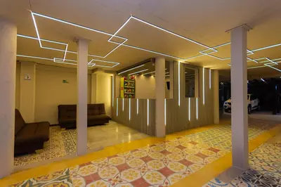 a lobby with a couch and chairs in a building at Hotel Bossanova in Rionegro