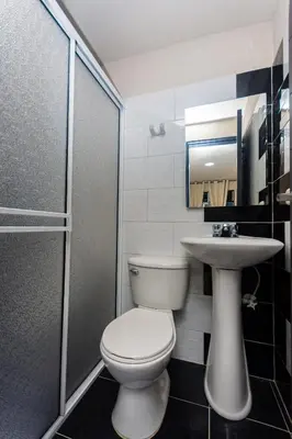 a bathroom with a toilet and a sink at Hotel Bossanova in Rionegro