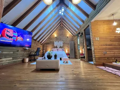 a living room with a large screen in a house at Qimera Ecolodge - Cabaña a 7 Min del Aeropuerto JMC in Guarne
