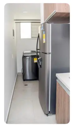 a kitchen with a stainless steel refrigerator in a room at Apartahotel Ginebra central cerca laureles in Medellín