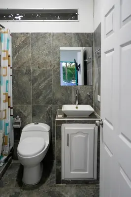 a bathroom with a toilet and a sink at Casa Hotel Villa Sabrosura in Mariquita