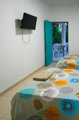 a room with two beds on the floor at Casa Hotel Villa Sabrosura in Mariquita