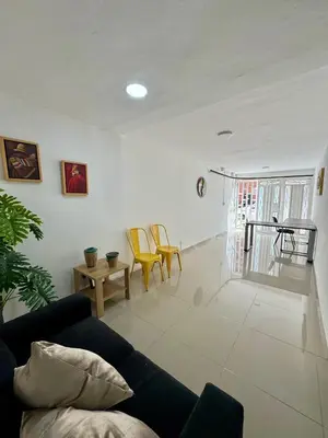 a living room with a couch and a table and chairs at Apartamento Blanco in Medellín