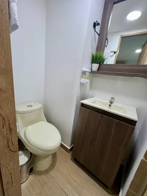 a bathroom with a toilet and a sink at Apartamento Blanco in Medellín