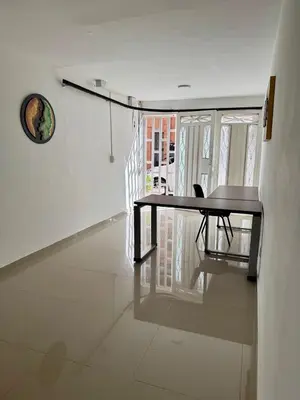 a table and a chair in a room at Apartamento Blanco in Medellín