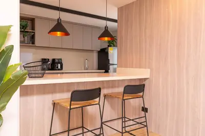 two chairs sitting at a counter in a kitchen at Jatisa Living by Housy in Medellín