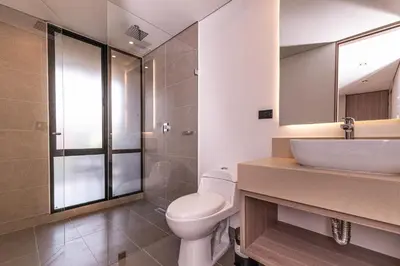 a bathroom with a toilet and a sink at Jatisa Living by Housy in Medellín