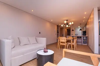 a living room with a couch and a table at Jatisa Living by Housy in Medellín