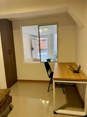 a room with a desk and a chair and a mirror at Apartamento la Sexta in Medellín