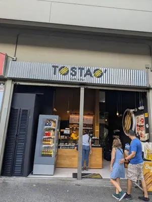 a group of people walking in front of a store at Baseloft in Medellín