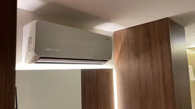 a television hanging from the ceiling of a room at One Apartments Provenza in Medellín