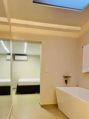 a room with a bed and a bath tub in it at One Apartments Provenza in Medellín